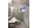 Compact bathroom featuring a single vanity, tub-shower combo, and tile flooring at 923 N Denny St, Indianapolis, IN 46201