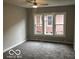 Well-lit bedroom boasts neutral tones, new carpet, and large windows offering ample natural light at 923 N Denny St, Indianapolis, IN 46201