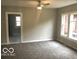Bright living area features fresh paint, new carpet, large windows, and ceiling fan at 923 N Denny St, Indianapolis, IN 46201