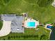 Aerial view of the home's backyard, featuring a pool, a deck, and a private boat dock at 995 Westlake Hills Dr, Columbus, IN 47201