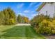 Expansive backyard featuring lush lawn, mature trees, and vibrant bushes for a private oasis at 995 Westlake Hills Dr, Columbus, IN 47201