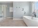 The relaxing bathroom features a stand-alone tub, shower, and elegant fixtures at 995 Westlake Hills Dr, Columbus, IN 47201