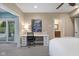 Bright bedroom featuring a waterfall art piece hanging over an organized desk; natural light from the slider doors at 995 Westlake Hills Dr, Columbus, IN 47201