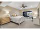 Comfortable bedroom with white bed frame, ceiling fan, stylish chalkboard wall, and desk area at 995 Westlake Hills Dr, Columbus, IN 47201