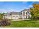Lovely white brick home with a well-manicured lawn, mature trees, and a three-car garage at 995 Westlake Hills Dr, Columbus, IN 47201