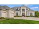 Beautiful white brick home with a grand entrance, manicured lawn and three-car garage at 995 Westlake Hills Dr, Columbus, IN 47201