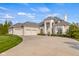 Charming white brick home boasting a three-car garage, a well-manicured lawn, and tasteful landscaping at 995 Westlake Hills Dr, Columbus, IN 47201