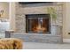 Elegant stone fireplace with glass door and hearth, complemented by a potted plant and inviting bedroom view at 995 Westlake Hills Dr, Columbus, IN 47201