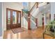 Inviting foyer with hardwood floors, elegant staircase, and a stylish front door at 995 Westlake Hills Dr, Columbus, IN 47201