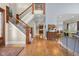Elegant foyer with hardwood floors, a grand staircase, and sophisticated decor at 995 Westlake Hills Dr, Columbus, IN 47201