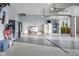 Spacious garage featuring epoxy floors, storage cabinets, shoe racks, a sink, and an extra refrigerator at 995 Westlake Hills Dr, Columbus, IN 47201