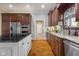 Open kitchen features stainless steel appliances, cherry cabinets, and a large island at 995 Westlake Hills Dr, Columbus, IN 47201