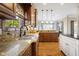 Kitchen area with a sink, tile backsplash, wood cabinets, and hardwood floors at 995 Westlake Hills Dr, Columbus, IN 47201
