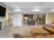 Spacious living room with neutral walls, carpet, bar, and a view of the stairs at 995 Westlake Hills Dr, Columbus, IN 47201
