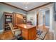 A home office features custom wood cabinets, a desk, and hardwood floors at 995 Westlake Hills Dr, Columbus, IN 47201