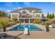 Stunning backyard oasis with a sparkling pool, diving board, lounge chairs, and manicured landscaping at 995 Westlake Hills Dr, Columbus, IN 47201