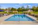 Inviting in-ground pool with a spacious patio area, lounge chairs, and manicured greenery creating a serene escape at 995 Westlake Hills Dr, Columbus, IN 47201
