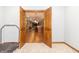 Open doorway from gym to the large finished basement rec room with a wet bar at 1115 Morningside Ct, Greenfield, IN 46140
