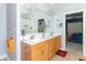 Spacious bathroom with tiled floors, wooden vanity, and direct access to the main bedroom at 1115 Morningside Ct, Greenfield, IN 46140