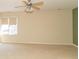 Bright, empty bedroom with tan carpeting, large window, and ceiling fan at 1115 Morningside Ct, Greenfield, IN 46140