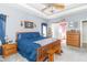 Large bedroom featuring gray walls and a wooden bed frame with a gray blanket at 1115 Morningside Ct, Greenfield, IN 46140
