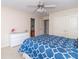 Neutral colored bedroom with blue patterned bedding and connecting bathroom at 1115 Morningside Ct, Greenfield, IN 46140