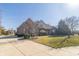 Well-maintained brick home with a spacious front yard, driveway and mature landscaping at 1115 Morningside Ct, Greenfield, IN 46140