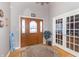 Welcoming foyer with hardwood floors, a decorative rug, and double french doors at 1115 Morningside Ct, Greenfield, IN 46140