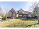 Charming brick home with a well-manicured lawn and landscaped front yard and mature landscaping at 1115 Morningside Ct, Greenfield, IN 46140