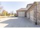 Spacious three-car garage with a large driveway surrounded by well-maintained landscaping and mature trees at 1115 Morningside Ct, Greenfield, IN 46140
