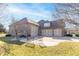 Spacious three-car garage with a wide driveway and a seating area at 1115 Morningside Ct, Greenfield, IN 46140