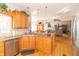 Updated kitchen with wooden cabinets, granite countertops, stainless steel appliances, and hardwood floors at 1115 Morningside Ct, Greenfield, IN 46140