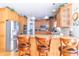 Bright kitchen featuring a breakfast bar with seating, stainless steel appliances, and wood cabinetry at 1115 Morningside Ct, Greenfield, IN 46140