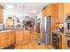 Open kitchen with hardwood floors and stainless steel appliances leading into the living room at 1115 Morningside Ct, Greenfield, IN 46140