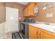 Laundry room with new appliances, built-in sink, and abundant cabinetry at 1115 Morningside Ct, Greenfield, IN 46140