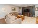 Cozy living room features comfortable seating, a fireplace, and a mounted television at 1115 Morningside Ct, Greenfield, IN 46140