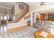 Inviting living room with a staircase, comfortable seating, and an open floor plan with kitchen access at 1115 Morningside Ct, Greenfield, IN 46140