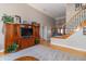 Spacious living room featuring high ceilings, a staircase, and a cozy seating area with TV at 1115 Morningside Ct, Greenfield, IN 46140