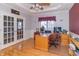 Home office with wood desk, french doors, hardwood floors, and neutral walls at 1115 Morningside Ct, Greenfield, IN 46140