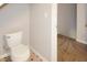 Bathroom area showcasing toilet, neutral walls and the flooring with an easy access to another room at 1149 W 28Th St, Indianapolis, IN 46208