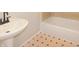 Classic bathroom design showcasing a pristine white sink, bathtub, and retro-style flooring for a timeless look at 1149 W 28Th St, Indianapolis, IN 46208