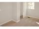 This carpeted bedroom features neutral walls and a window that lets in natural light for a relaxing atmosphere at 1149 W 28Th St, Indianapolis, IN 46208