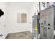 Functional utility room with essential appliances and neutral decor for efficient home maintenance at 11609 Hartwell St, Indianapolis, IN 46235