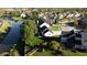 Scenic aerial perspective of a home adjacent to a tranquil pond, surrounded by lush greenery and neighboring houses at 11907 Ledgestone Cir, Fishers, IN 46037