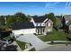 Spacious home with a three-car garage, expansive driveway, and well-maintained landscaping in a serene setting at 11907 Ledgestone Cir, Fishers, IN 46037