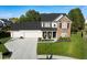 Well-manicured lawn and professional landscaping surround this lovely home with attached three-car garage at 11907 Ledgestone Cir, Fishers, IN 46037