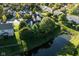 Aerial view of a residential neighborhood with well-manicured lawns and a serene pond at 11907 Ledgestone Cir, Fishers, IN 46037