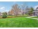 Expansive backyard with lush green lawn, mature trees, and a charming wooden fence at 11907 Ledgestone Cir, Fishers, IN 46037