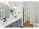 Bathroom with a modern double vanity and stylish mirrors at 11907 Ledgestone Cir, Fishers, IN 46037