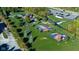 Aerial view of the community park with basketball courts, playground, parking, and green space, perfect for recreation at 11907 Ledgestone Cir, Fishers, IN 46037